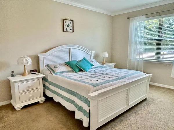 a bedroom with a bed and window