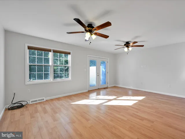 a view of a livingroom with a ceiling fan and window