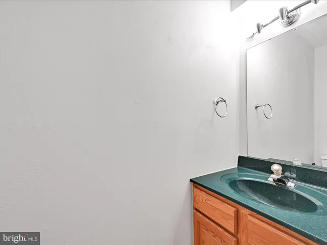 a bathroom with a granite countertop sink and vanity