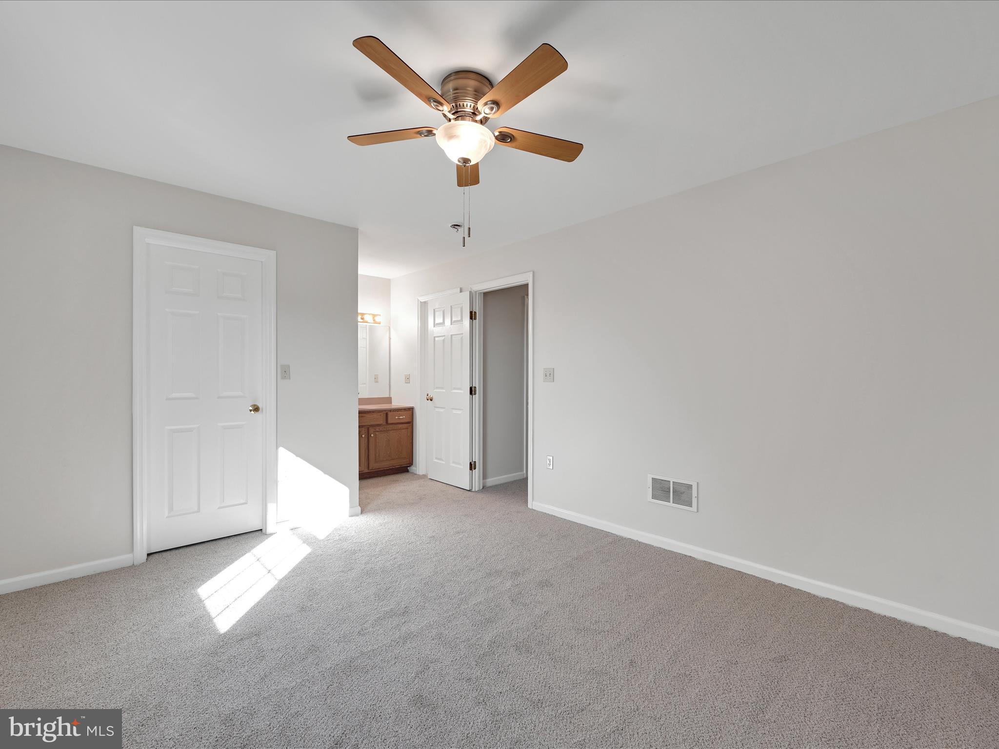 70 Pebble Creek Drive Lititz, PA 17543 - Photo 16 of 26 an empty room with a ceiling fan and a window