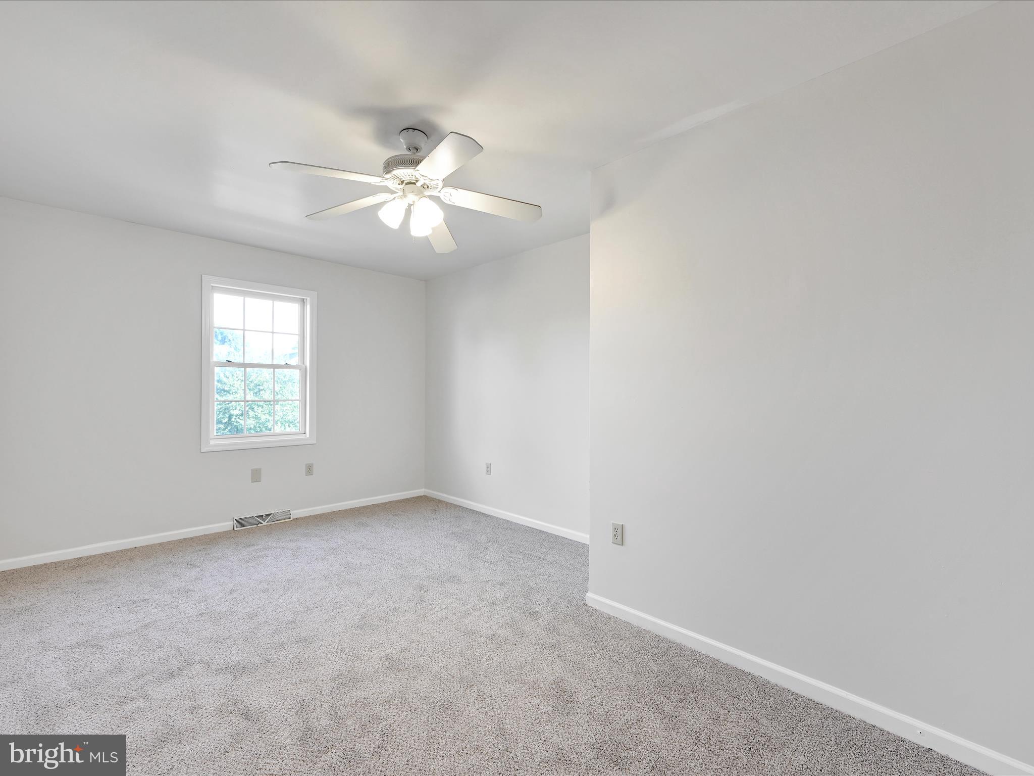 70 Pebble Creek Drive Lititz, PA 17543 - Photo 18 of 26 an empty room with a window and a fan