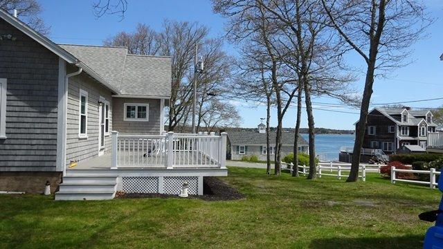 54 Jefferson Shores Road Buzzards Bay, MA 02532 - Photo 22 of 28 a view of a chair and table in backyard of the house