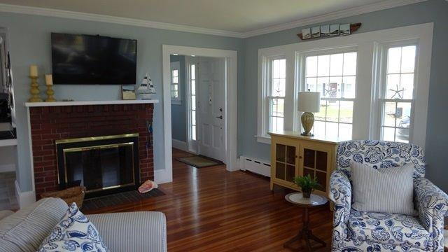 54 Jefferson Shores Road Buzzards Bay, MA 02532 - Photo 6 of 28 a living room with furniture a flat screen tv and a fireplace