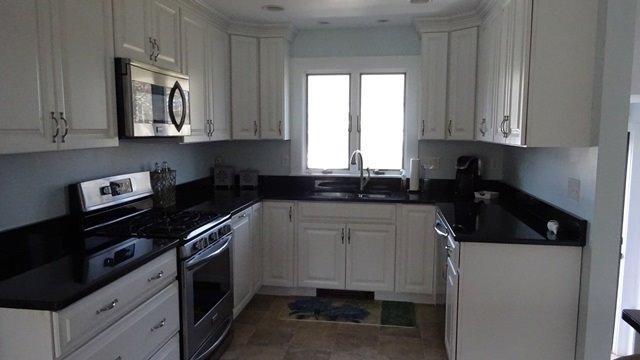 54 Jefferson Shores Road Buzzards Bay, MA 02532 - Photo 8 of 28 a kitchen with cabinets appliances a sink and a window