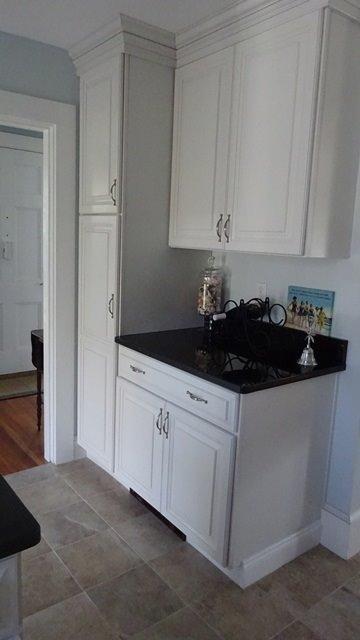 54 Jefferson Shores Road Buzzards Bay, MA 02532 - Photo 9 of 28 a kitchen with granite countertop white cabinets and black appliances
