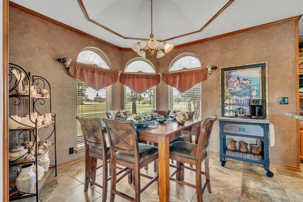 50 Buckingham Lane Allen, TX 75002 - Photo 18 of 39 Dining room with a chandelier, crown molding, and light stone finish flooring