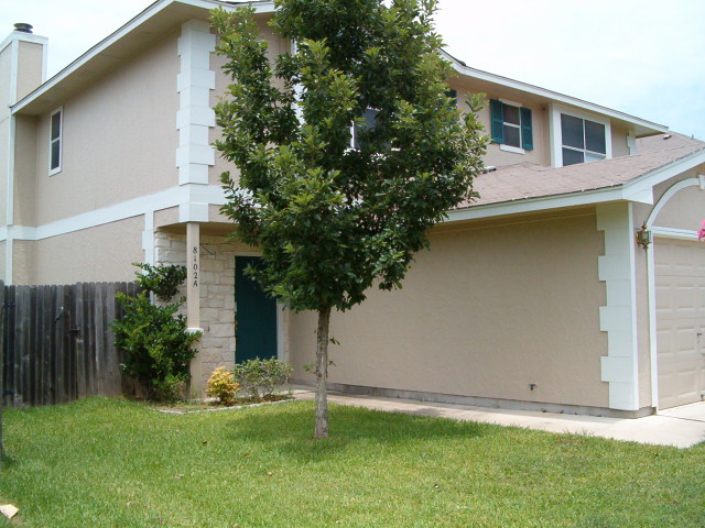 8102 Willet Trail, Unit A Austin, TX 78745 - Photo 2 of 3 a front view of a house with a yard