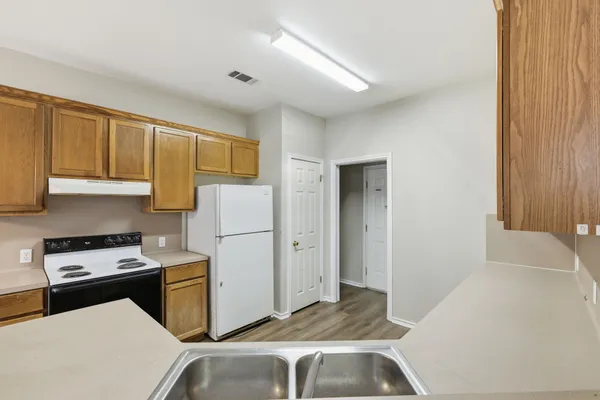 a kitchen with a refrigerator sink and stove