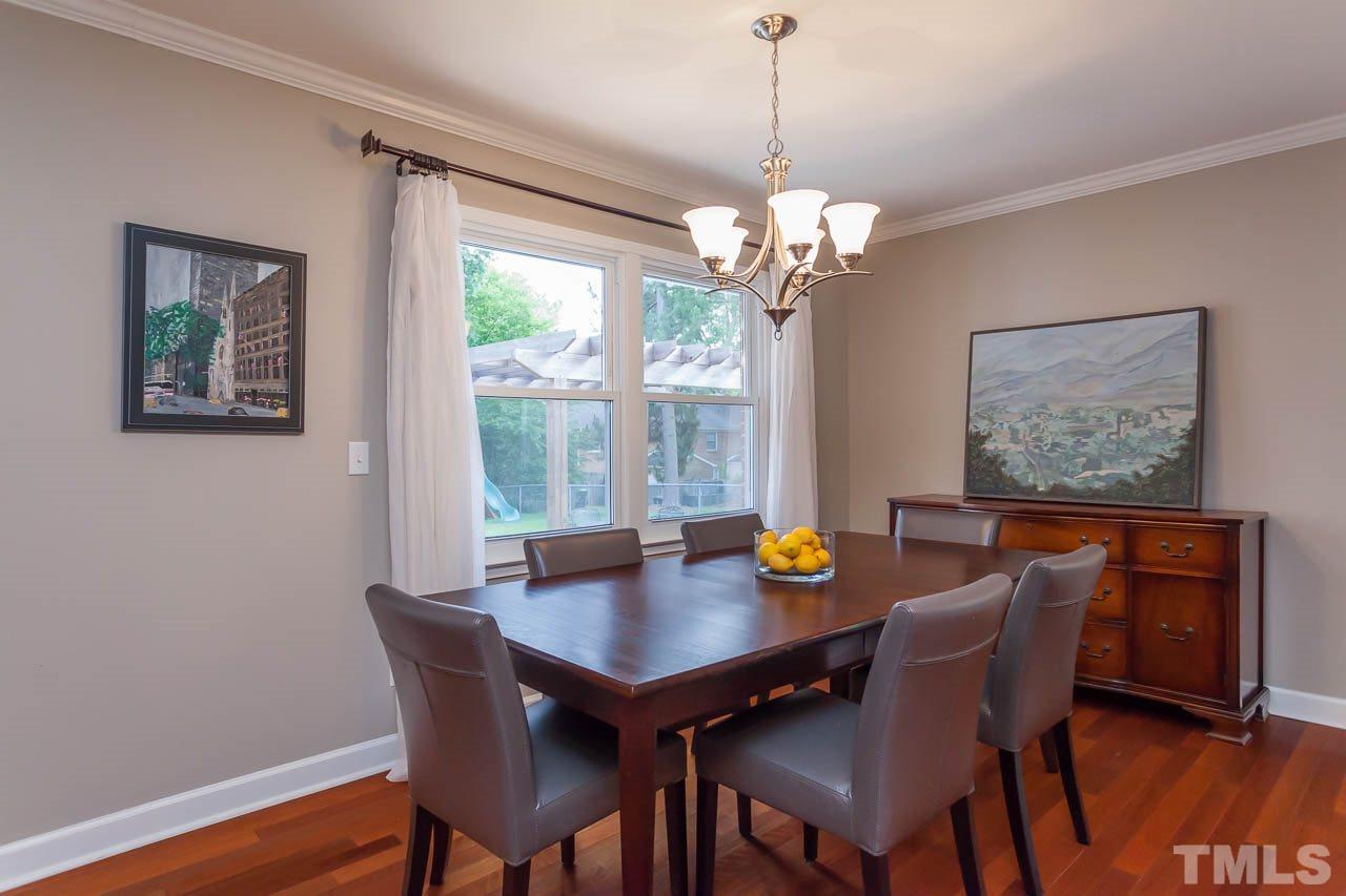 3145 Merrianne Drive Raleigh, NC 27607 - Photo 11 of 25 a view of a dining room with furniture window and wooden floor