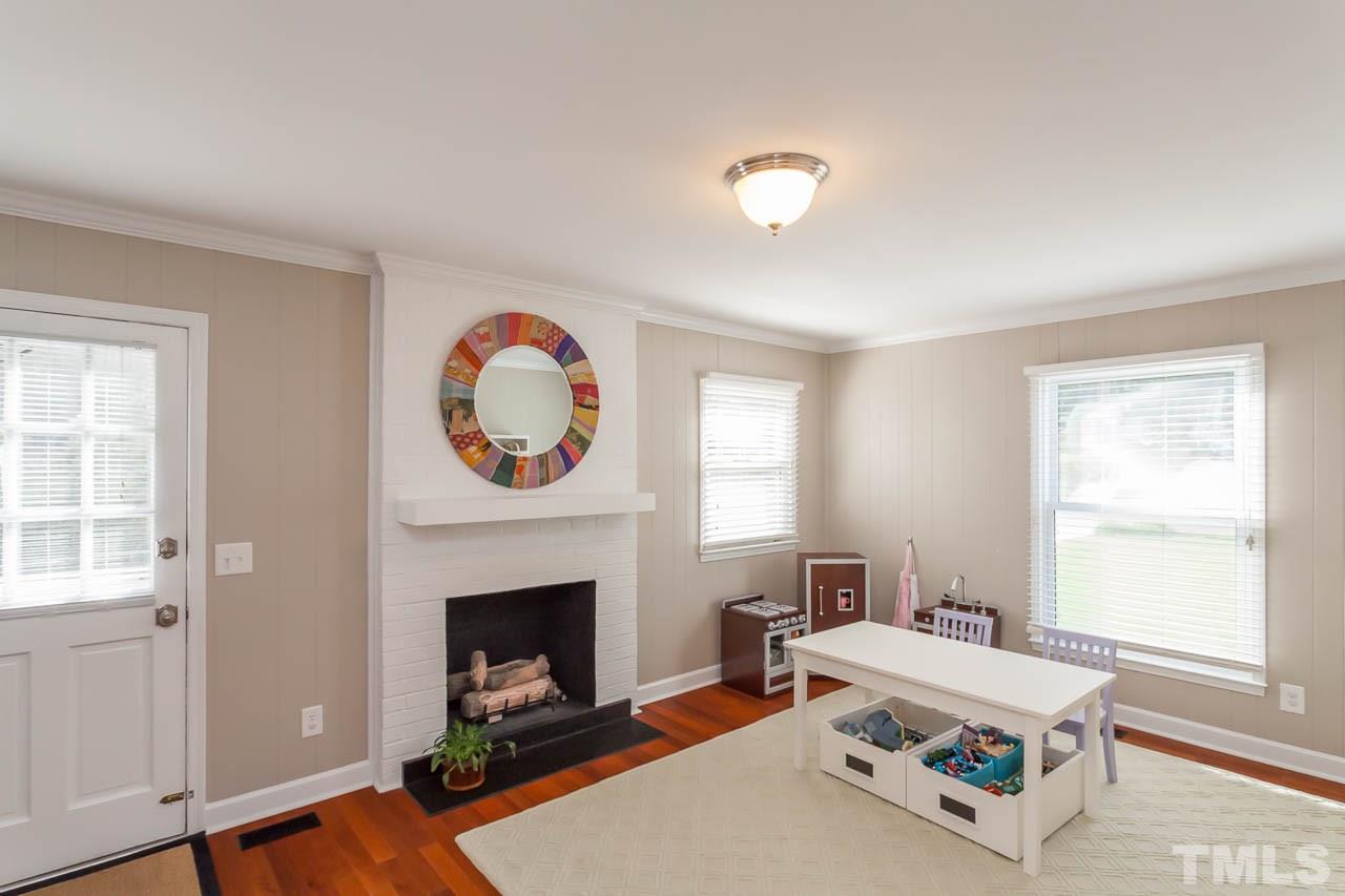 3145 Merrianne Drive Raleigh, NC 27607 - Photo 13 of 25 a living room with furniture a fireplace and window