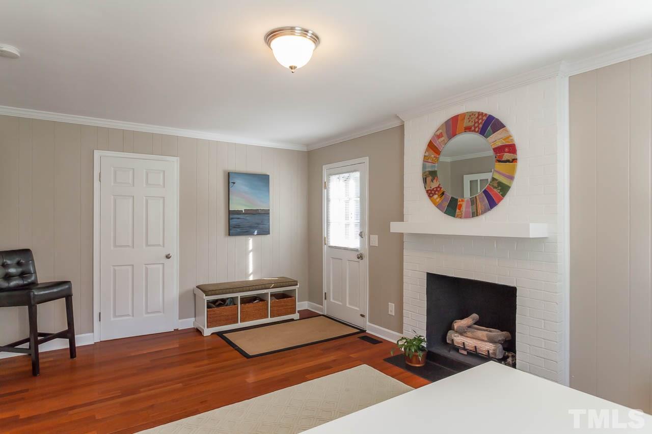 3145 Merrianne Drive Raleigh, NC 27607 - Photo 14 of 25 a living room with furniture and a fireplace