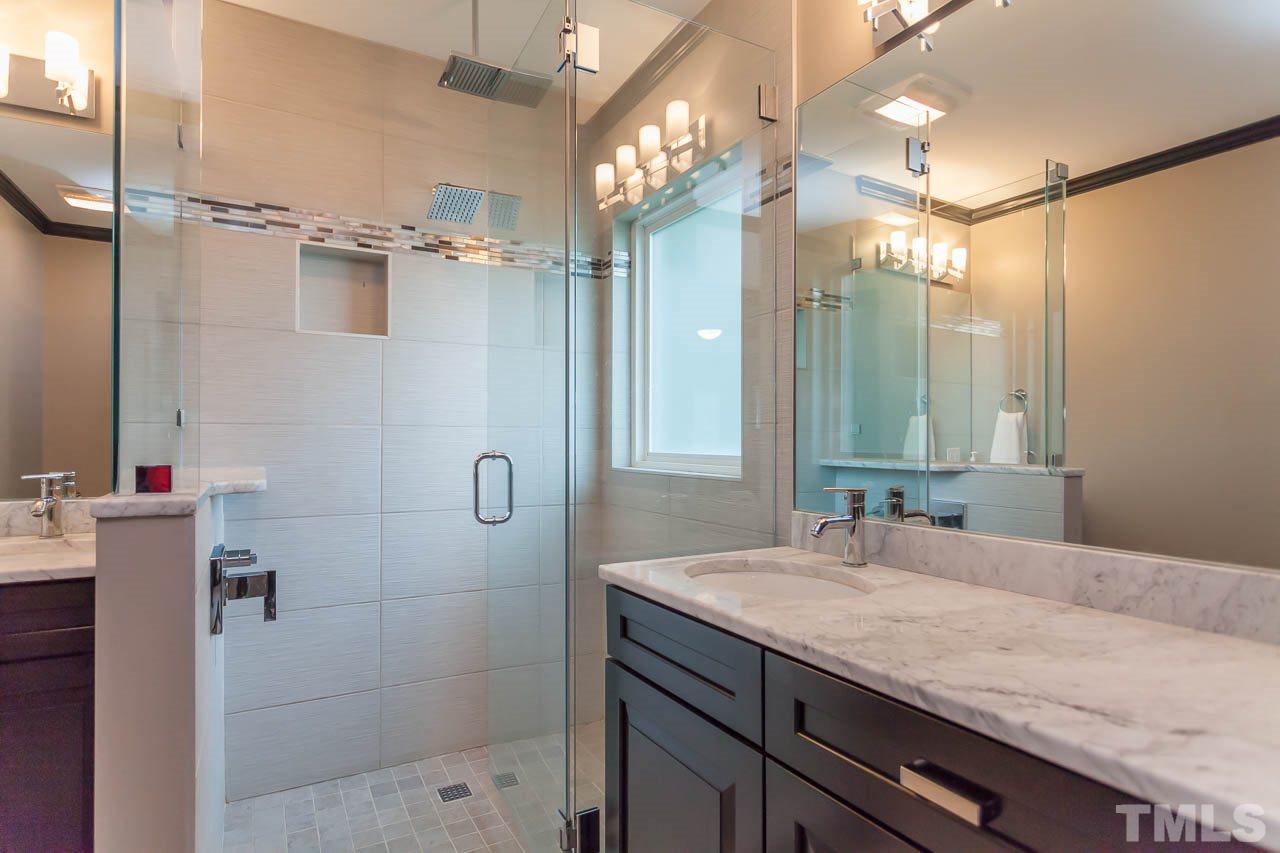 3145 Merrianne Drive Raleigh, NC 27607 - Photo 16 of 25 a bathroom with a granite countertop sink a mirror and shower