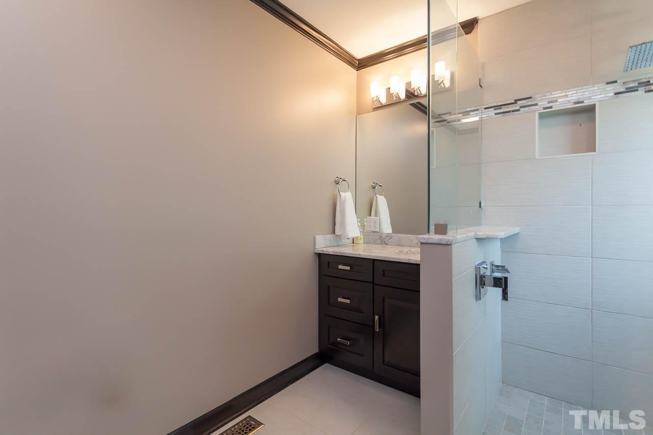 3145 Merrianne Drive Raleigh, NC 27607 - Photo 17 of 25 a bathroom with a sink a light fixture and a mirror