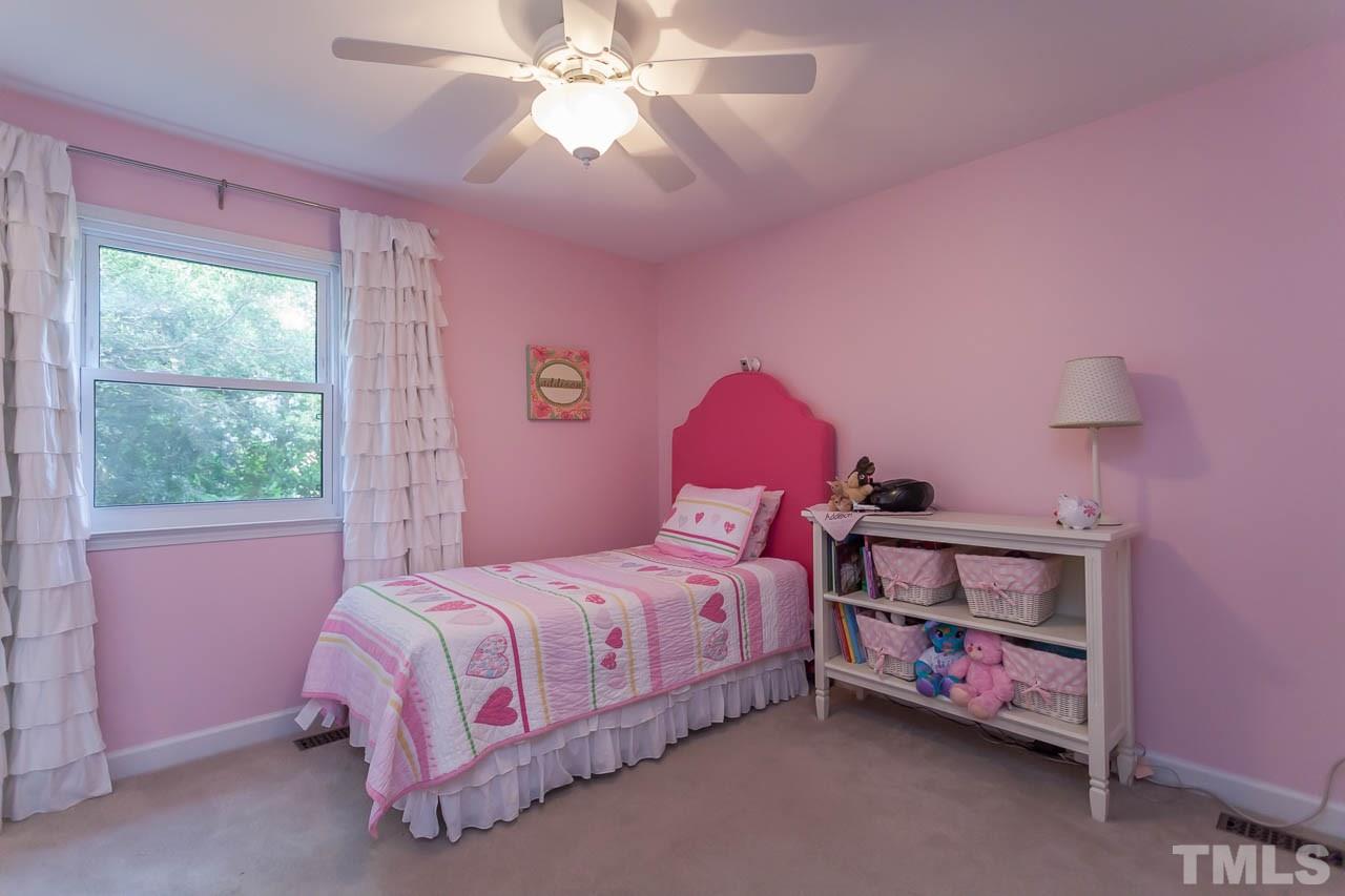 3145 Merrianne Drive Raleigh, NC 27607 - Photo 18 of 25 a bedroom with a bed and a chandelier