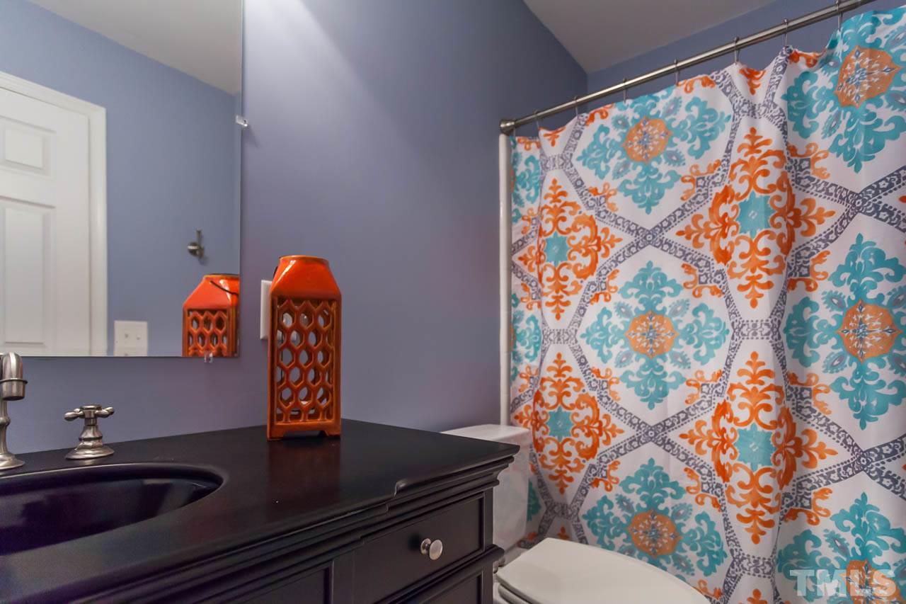 3145 Merrianne Drive Raleigh, NC 27607 - Photo 22 of 25 a bathroom with a sink and a mirror