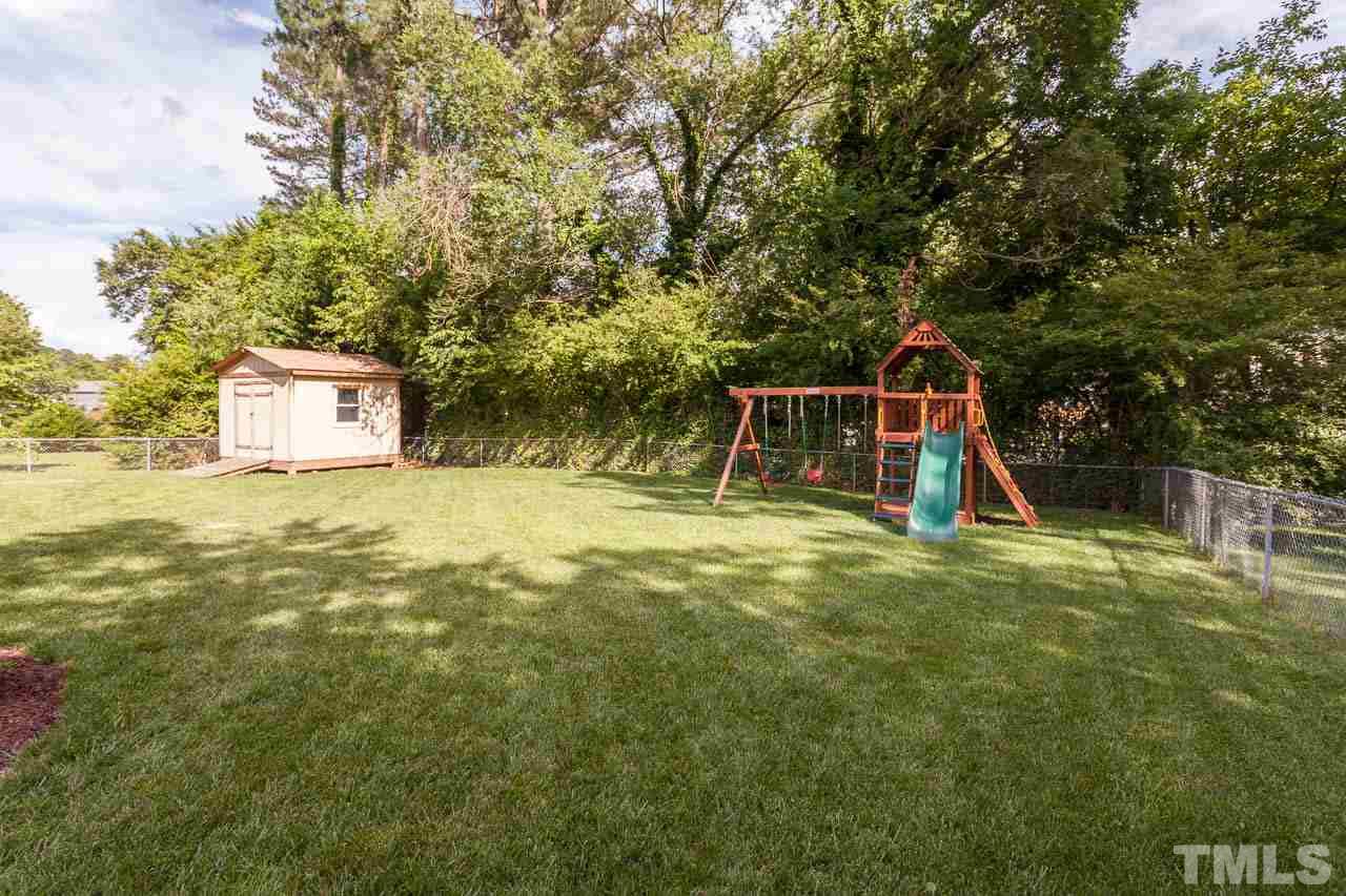 3145 Merrianne Drive Raleigh, NC 27607 - Photo 24 of 25 a small pool with trees in the background