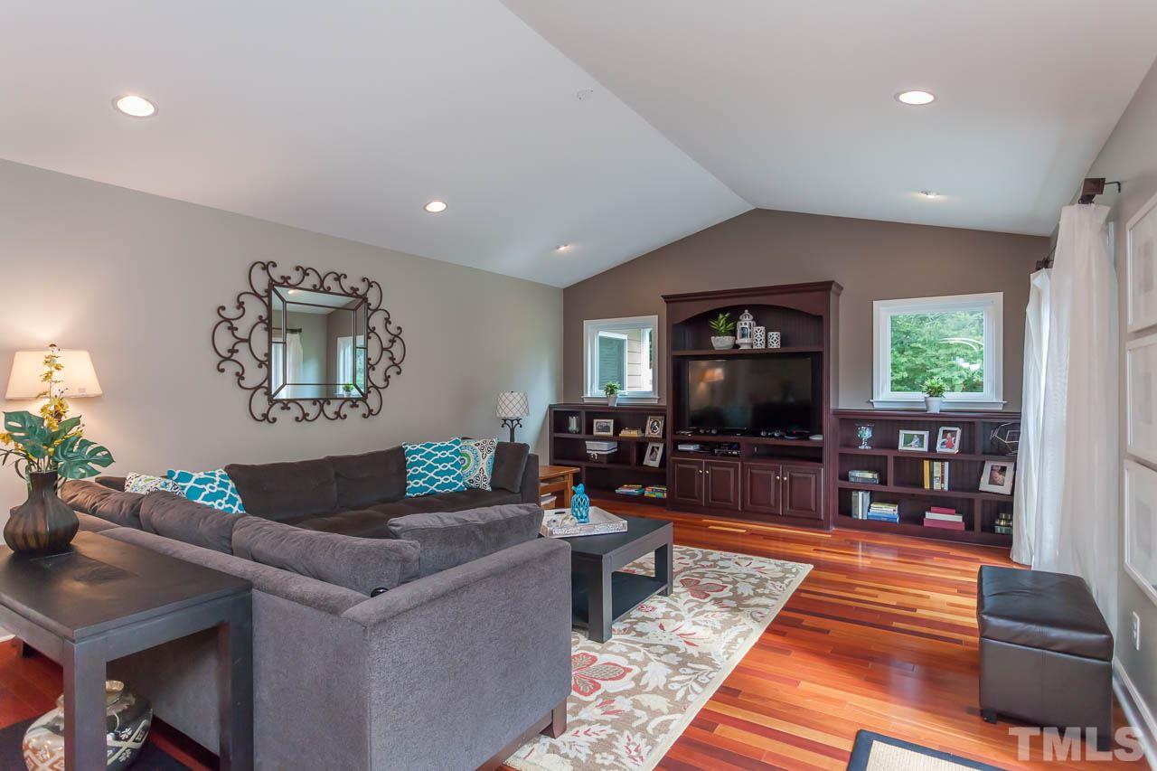 3145 Merrianne Drive Raleigh, NC 27607 - Photo 4 of 25 a living room with furniture and a flat screen tv