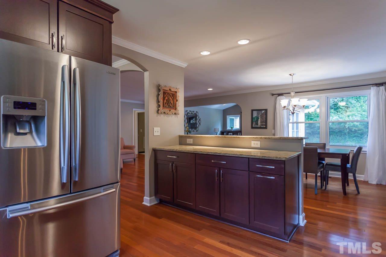 3145 Merrianne Drive Raleigh, NC 27607 - Photo 8 of 25 a kitchen with stainless steel appliances granite countertop a refrigerator a sink dishwasher a stove and a refrigerator