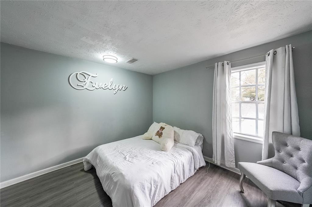 400 Winding River Drive, Unit E Atlanta, GA 30350 - Photo 22 of 34 a bedroom with a bed and window