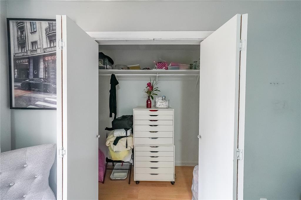 400 Winding River Drive, Unit E Atlanta, GA 30350 - Photo 23 of 34 a view of walk in closet with clothes and shoes