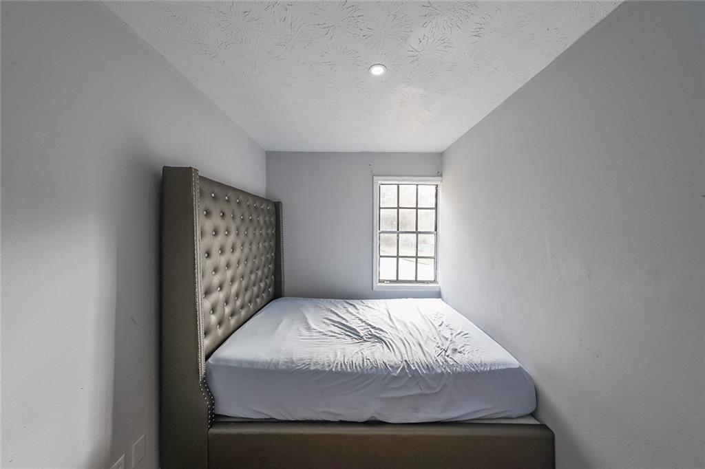 400 Winding River Drive, Unit E Atlanta, GA 30350 - Photo 25 of 34 a bedroom with a bed and a window