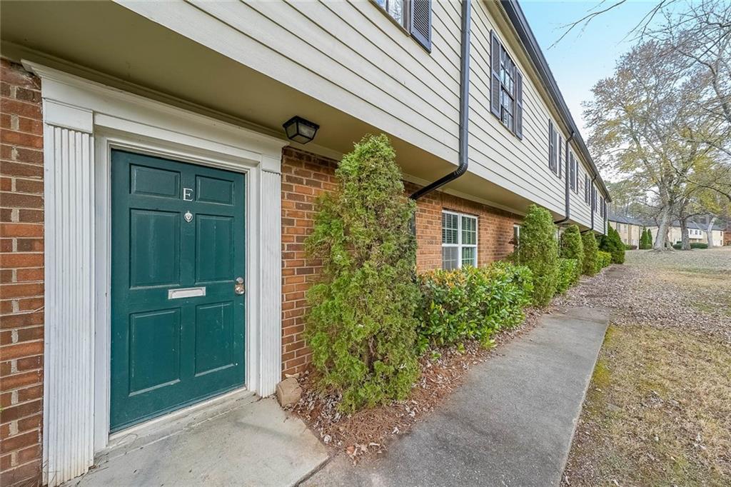 400 Winding River Drive, Unit E Atlanta, GA 30350 - Photo 4 of 34 a view of a house with a yard
