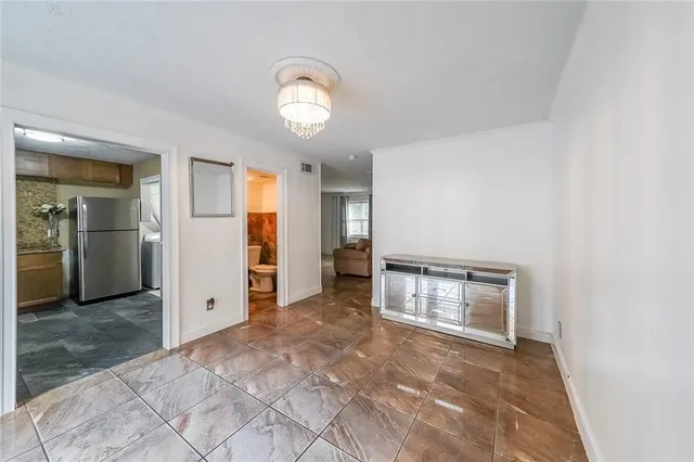 an empty room with closet and mirror