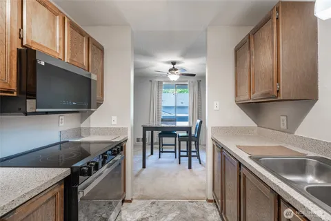 a kitchen with a stove a sink and a microwave