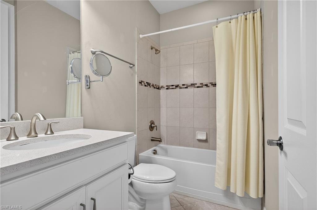 6345 Liberty Street Ave Maria, FL 34142 - Photo 25 of 35 a bathroom with a sink a toilet and shower