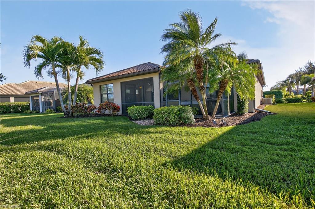 6345 Liberty Street Ave Maria, FL 34142 - Photo 29 of 35 a front view of house with yard and green space