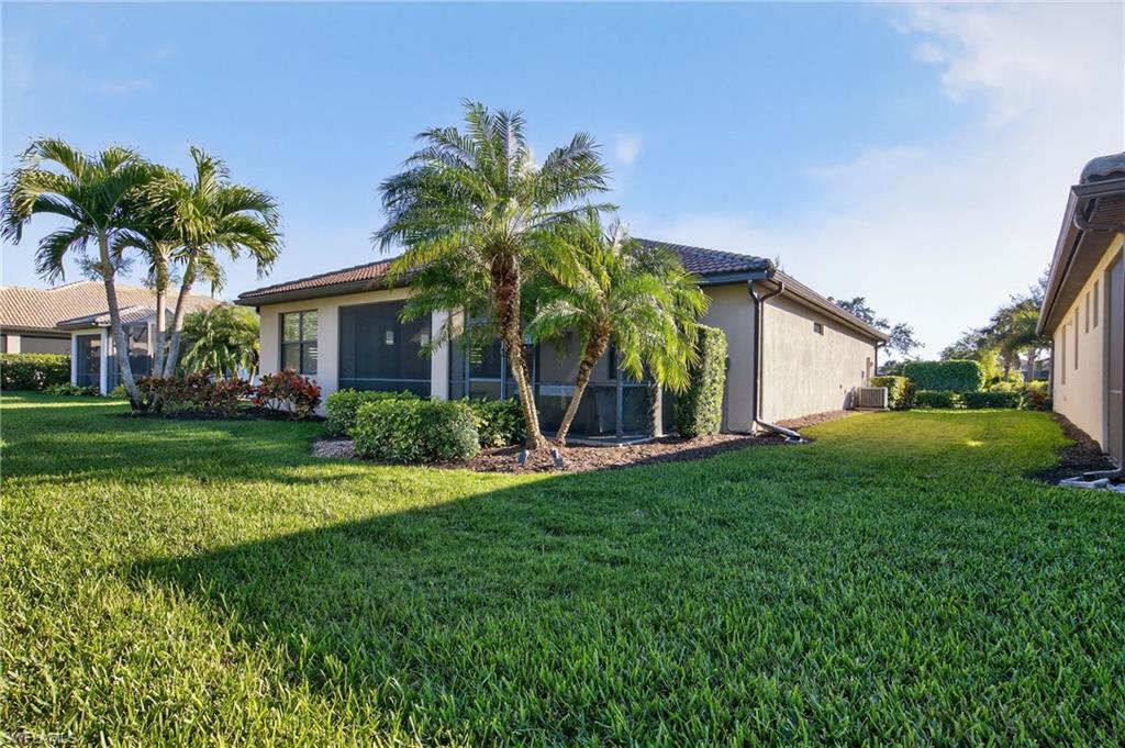 6345 Liberty Street Ave Maria, FL 34142 - Photo 30 of 35 a front view of house with yard and green space
