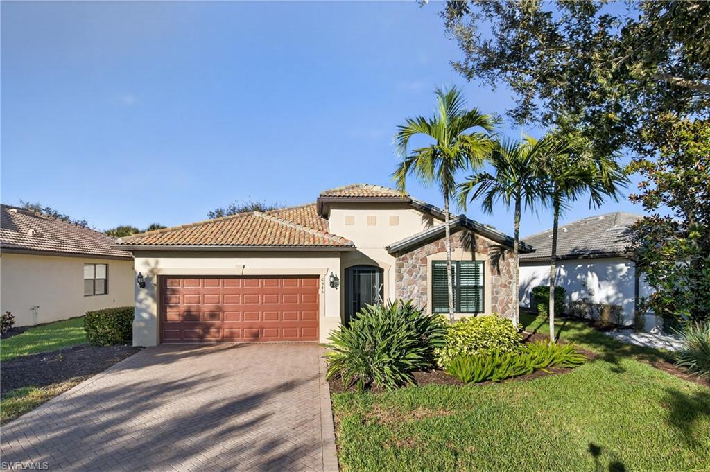 6345 Liberty Street Ave Maria, FL 34142 - Photo 31 of 35 a front view of a house with a garden