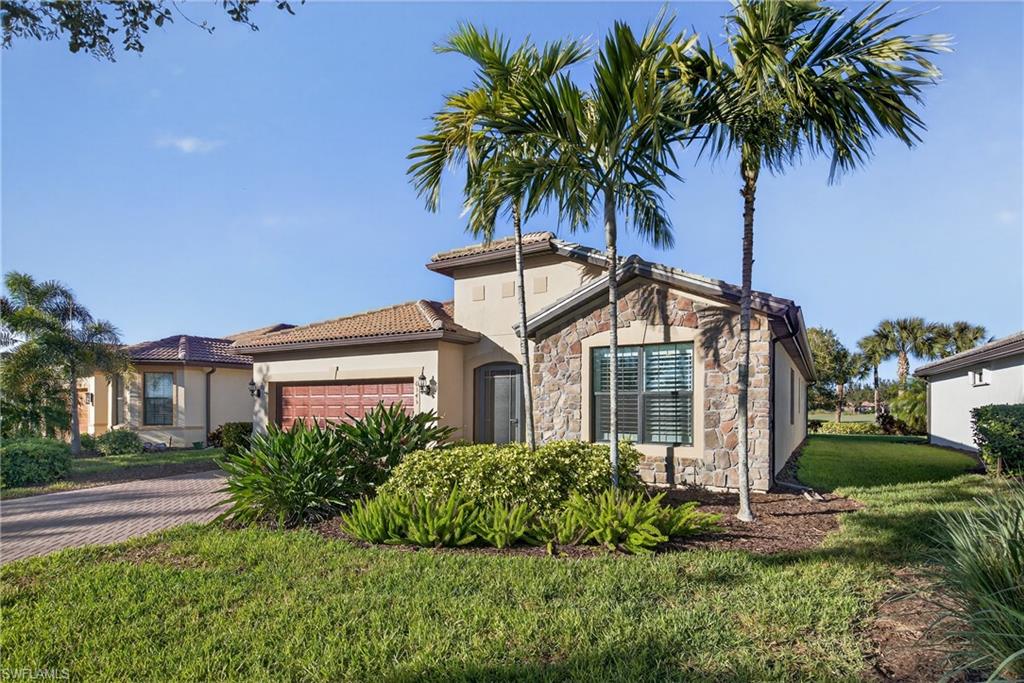 6345 Liberty Street Ave Maria, FL 34142 - Photo 32 of 35 a front view of a house with a garden