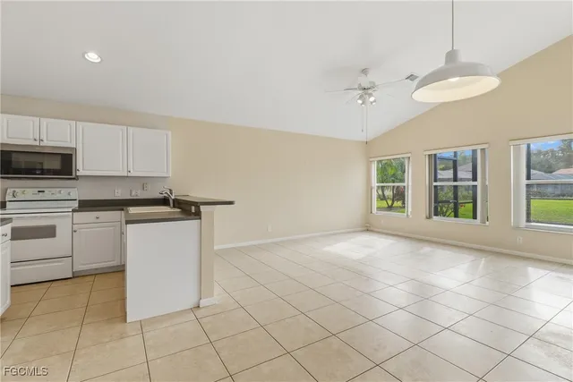 a kitchen with stainless steel appliances a refrigerator sink and cabinets