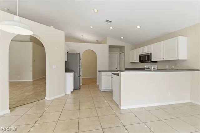 a kitchen with stainless steel appliances granite countertop a refrigerator sink and stove