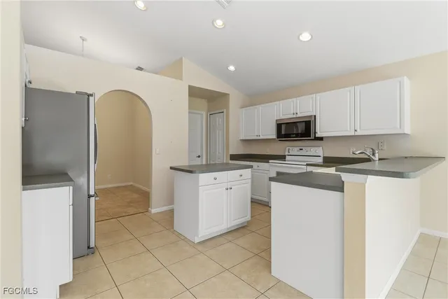 a kitchen with stainless steel appliances granite countertop a sink and cabinets