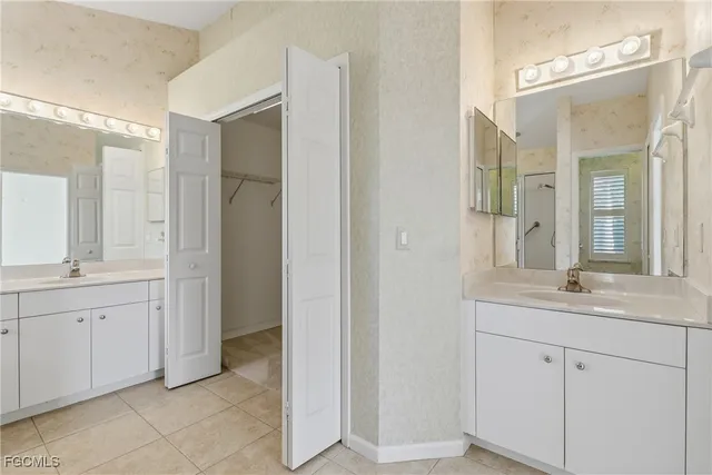 a bathroom with a tub sink shower and mirror