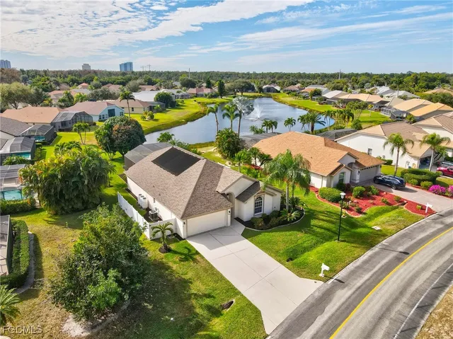 an aerial view of a house with a yard and fountain