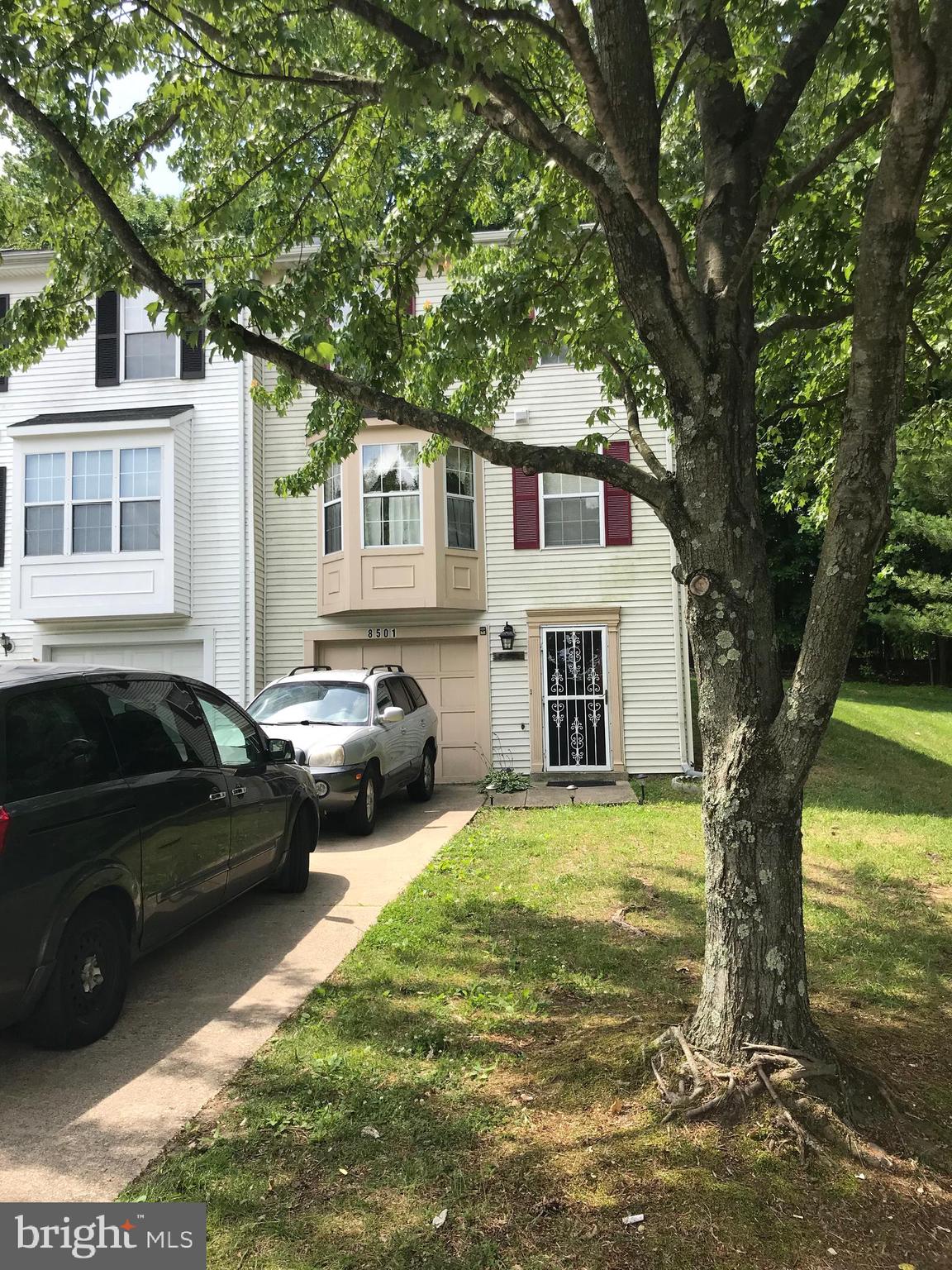 8501 Ritchboro Road District Heights, MD 20747 - Photo 2 of 17 a view of a car parked in front of a house with a large tree