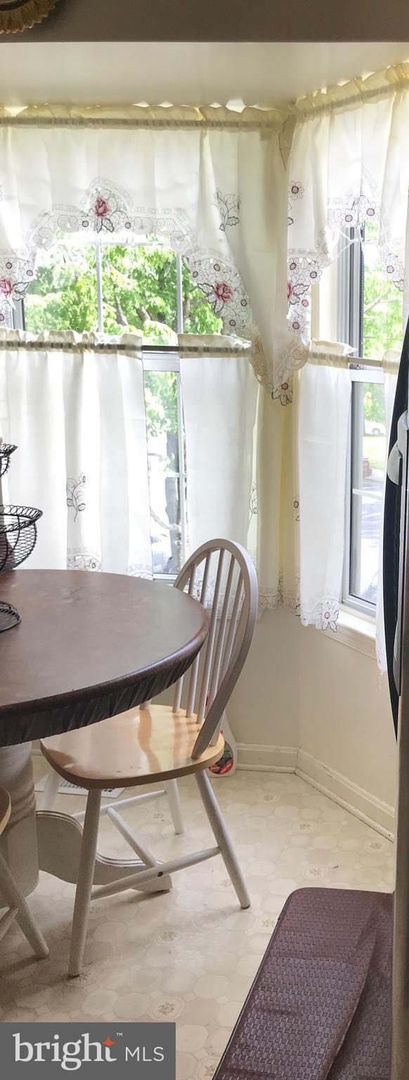 8501 Ritchboro Road District Heights, MD 20747 - Photo 13 of 17 a view of a dining room with furniture window and wooden floor