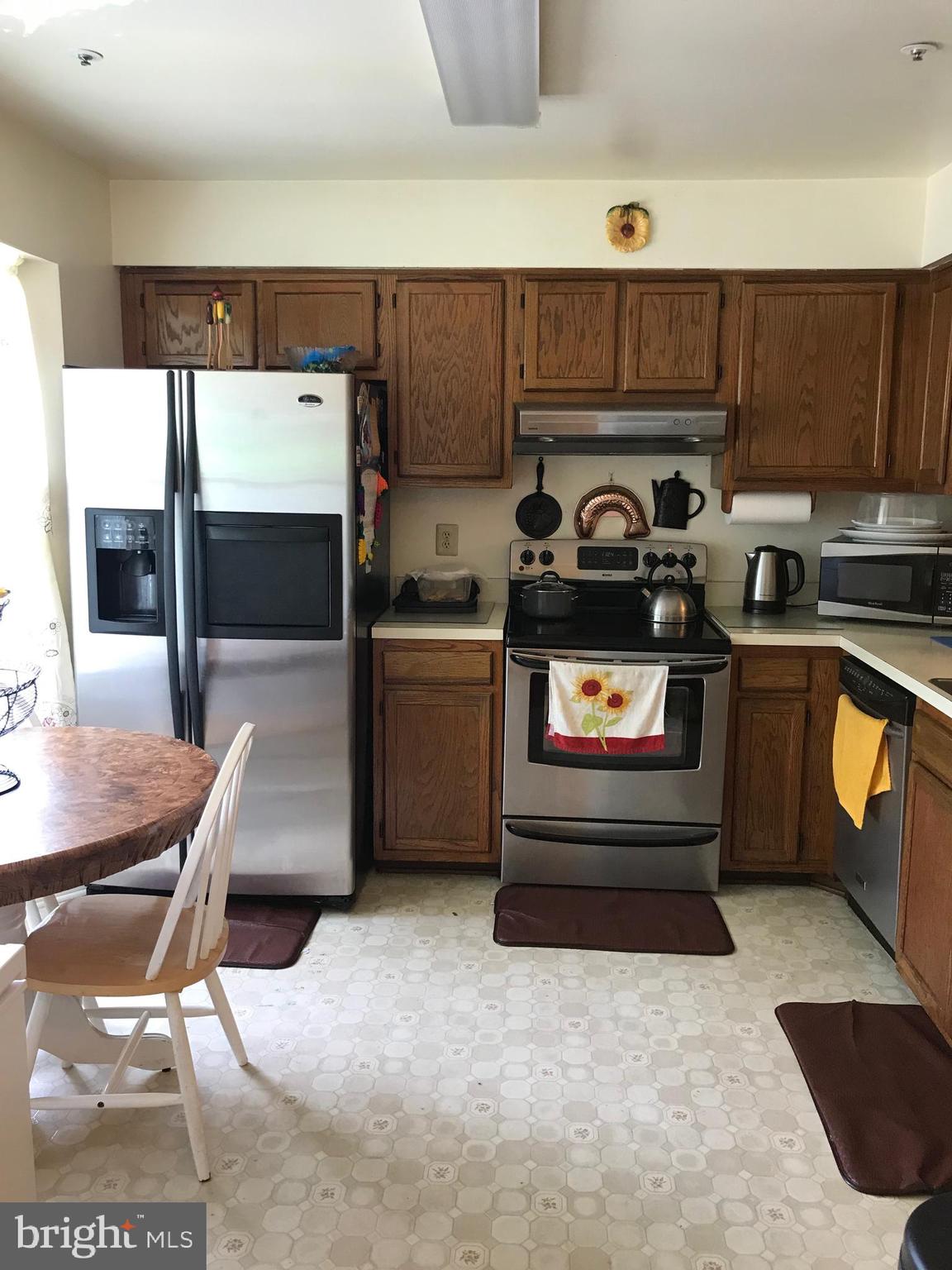 8501 Ritchboro Road District Heights, MD 20747 - Photo 5 of 17 a kitchen with a stove and a refrigerator