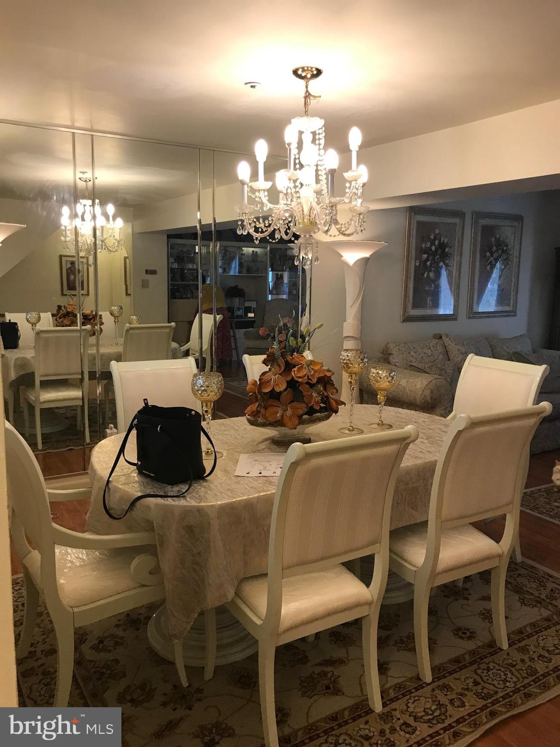 8501 Ritchboro Road District Heights, MD 20747 - Photo 9 of 17 a dining room with furniture a chandelier and window