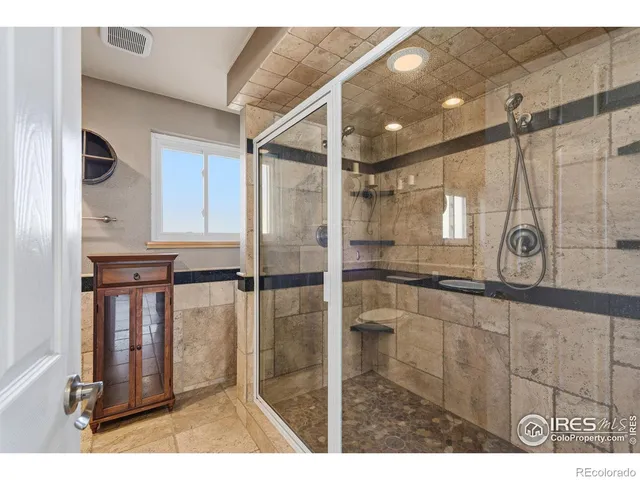 a bathroom with a shower and a mirror