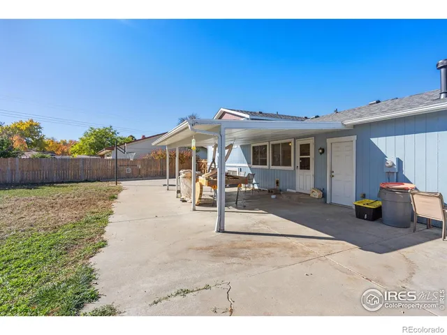 a view of a patio with a table and chairs