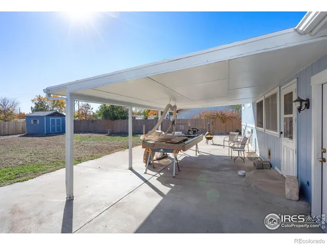 a view of a house with backyard porch and sitting area
