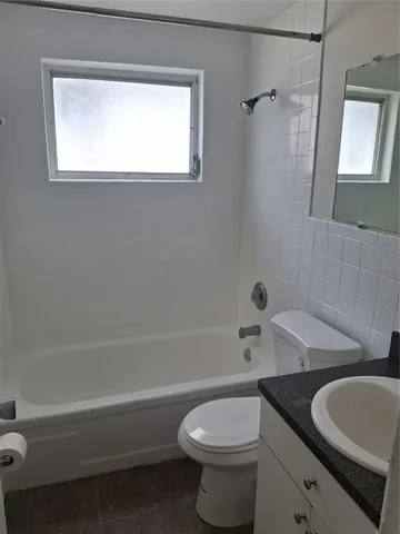 a bathroom with a toilet a sink and bathtub