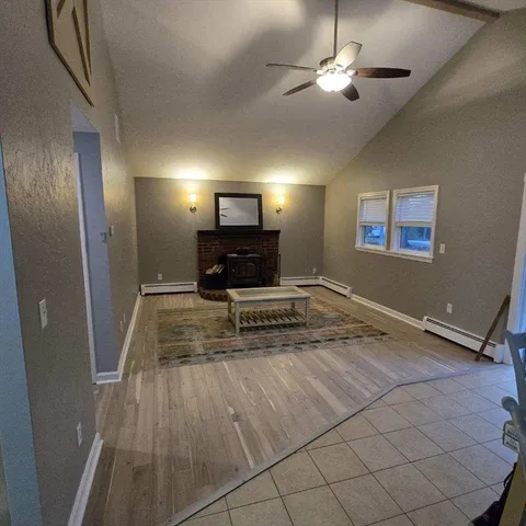 a view of kitchen with furniture and a fireplace