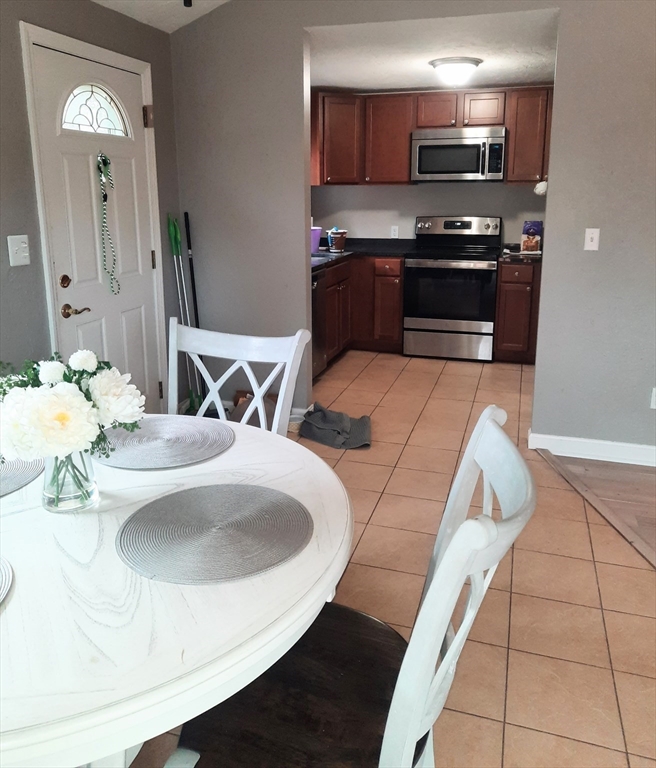 633 Wareham Road, Unit 1 Plymouth, MA 02360 - Photo 3 of 12 a kitchen with stainless steel appliances kitchen island granite countertop a sink and a stove