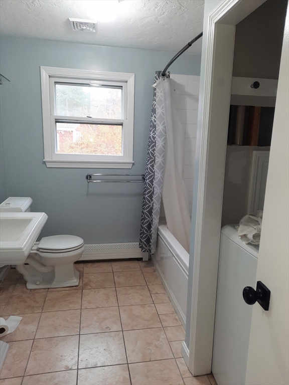 633 Wareham Road, Unit 1 Plymouth, MA 02360 - Photo 7 of 12 a bathroom with a toilet a sink a mirror and shower