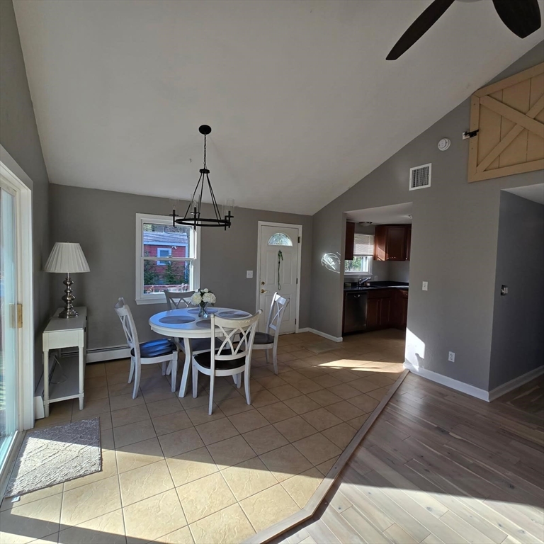 633 Wareham Road, Unit 1 Plymouth, MA 02360 - Photo 8 of 12 a dining room with furniture a chandelier and wooden floor
